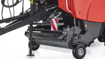 Wahliwie zawieszony szeroki podbieracz prowadzony na krzywce z rolką dociskową podbieracza z osłoną do ciężkiego pokosu